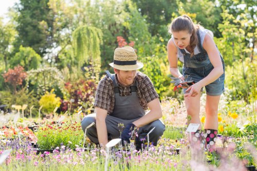 Team of gardeners arriving at a residential property with tools